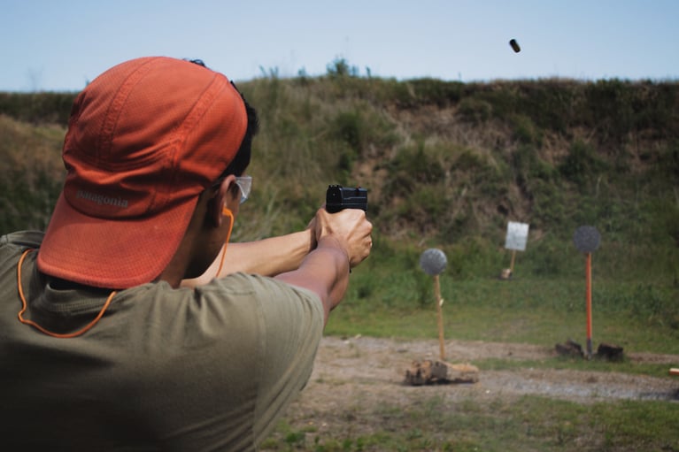 A man aiming a pistol at a target